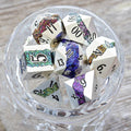 Cool seven piece metal polyhedral dnd dice set in silver metal with beautiful stripes of glittery rainbow resin.
