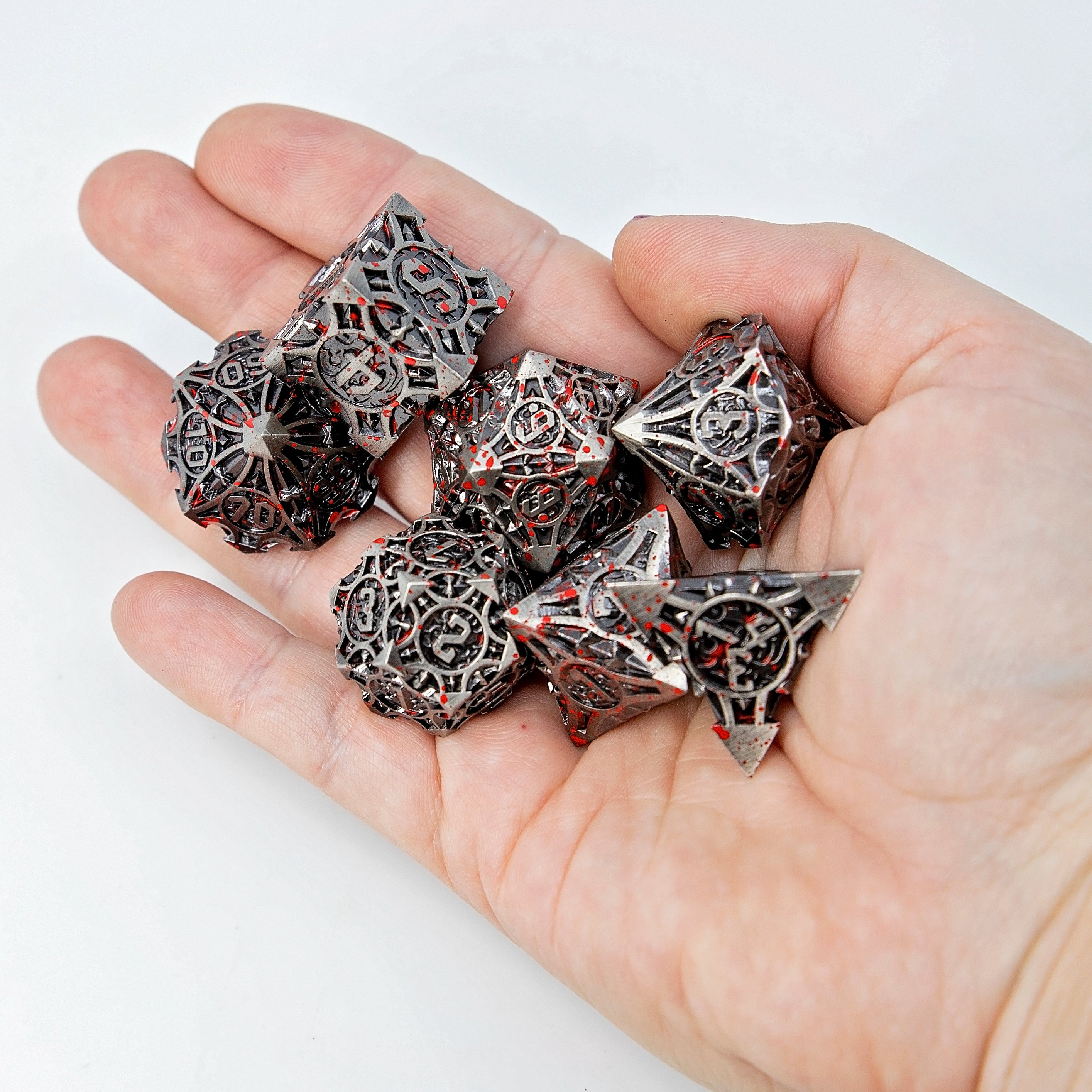 Sage’s Runic Caltrops Nickel Blood Splatter Solid Metal Polyhedral Dice Set