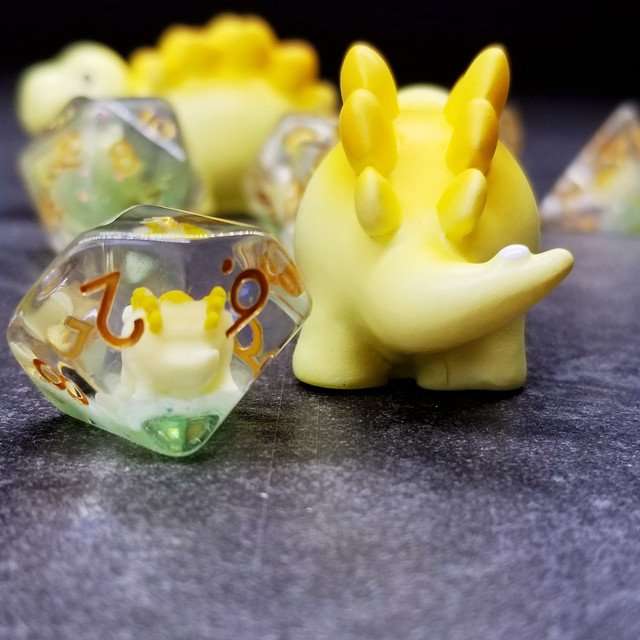 Sage's Familiars - Yellow Baby Stegosaurus Resin Polyhedral Dice Set - Sage's PortalResin Dice + Figurine Set
