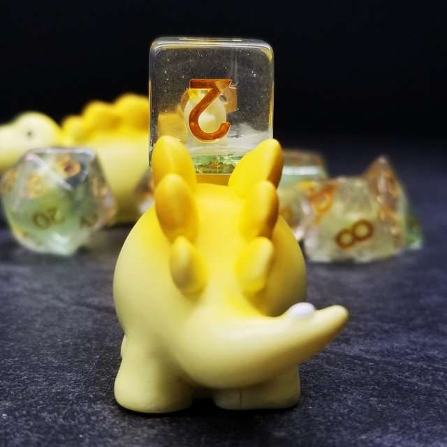 Sage's Familiars - Yellow Baby Stegosaurus Resin Polyhedral Dice Set - Sage's PortalResin Dice + Figurine Set