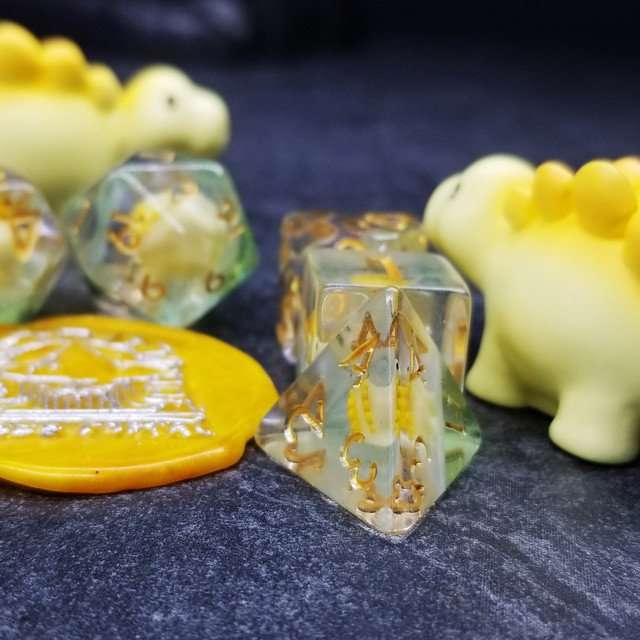 Sage's Familiars - Yellow Baby Stegosaurus Resin Polyhedral Dice Set - Sage's PortalResin Dice + Figurine Set